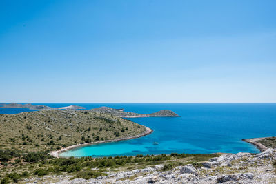 Scenic view of sea against clear blue sky