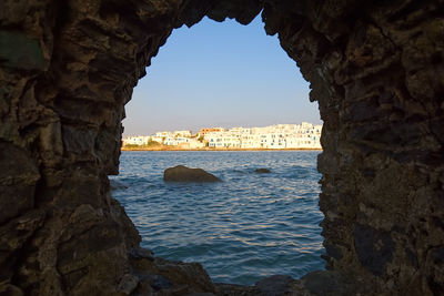 Rock formations in sea against sky