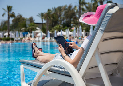 Man using mobile phone in swimming pool