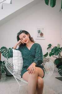 Young woman sitting on chair at cafe