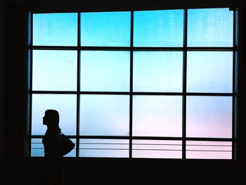 Silhouette woman walking in parking lot