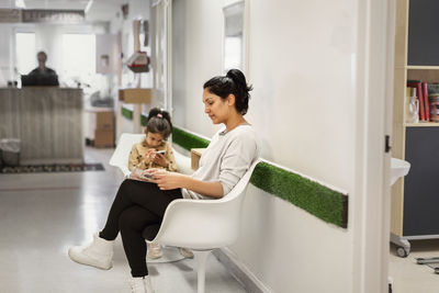 Mother with daughter in waiting room