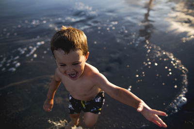 High angle view of boy swimming in sea