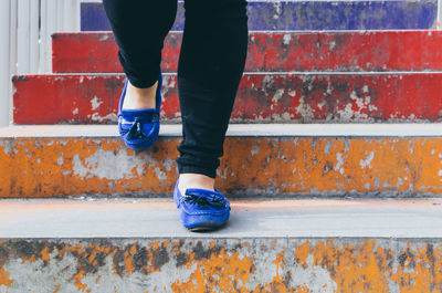 Low section of man moving down on steps