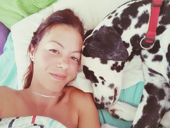 Portrait of a smiling girl lying on bed