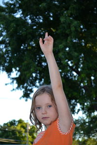 Portrait of girl smiling against trees