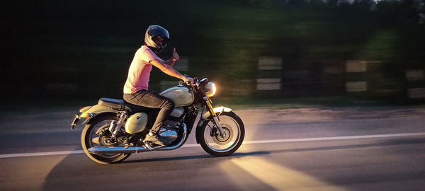 Man riding motorcycle on road