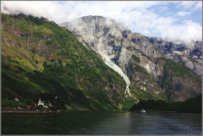 Scenic view of lake against cloudy sky