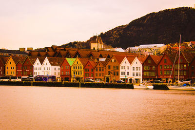 Houses by mountain against sky