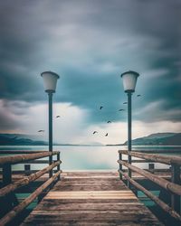 Street light on pier against sky