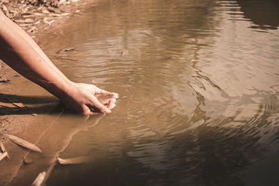 High angle view of hand in lake