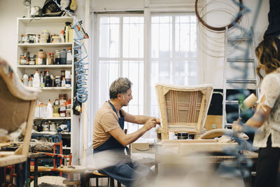 Entrepreneurs making furniture in upholstery workshop