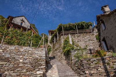 Footpath by old building against sky