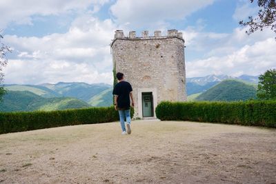 Rear view of man standing on mountain