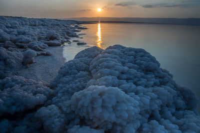 Sunset at the lowest point in the earth in the dead sea , where located in south of jordan