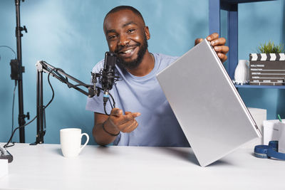 Portrait of man using digital tablet on table