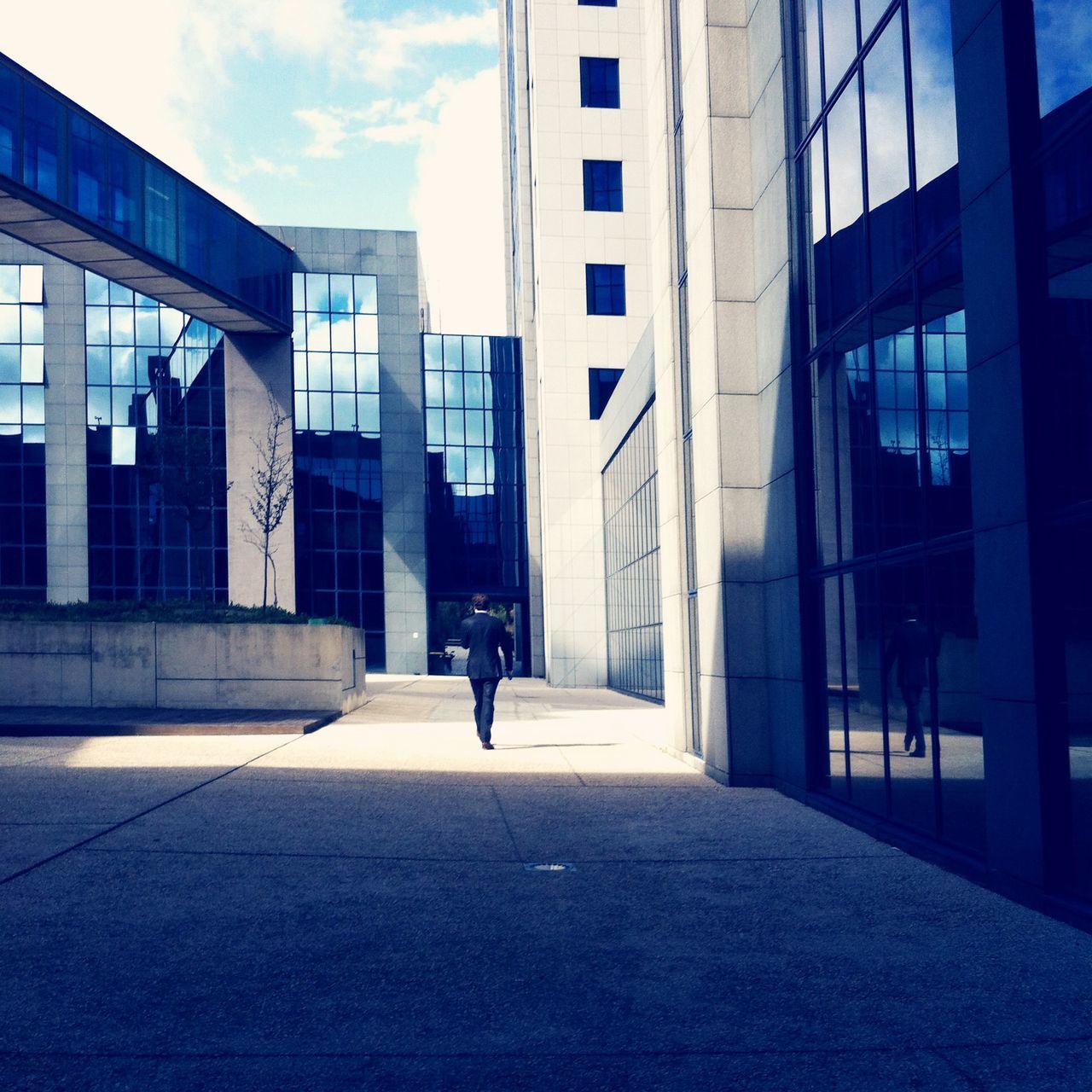 architecture, built structure, building exterior, city, sky, building, men, walking, street, lifestyles, city life, full length, modern, the way forward, day, sunlight, office building, person