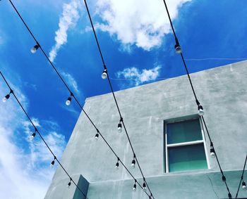 Low angle view of cables against blue sky