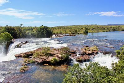 Scenic view of waterfall against sky