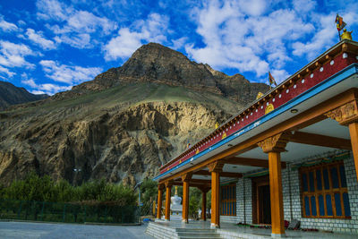 Scenic view of mountain range against cloudy sky