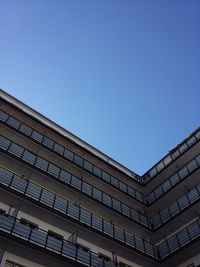Low angle view of buildings against clear blue sky