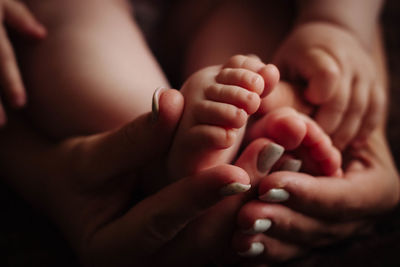 Close-up of hands holding baby hand