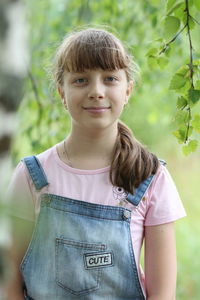 Portrait of smiling girl standing outdoors