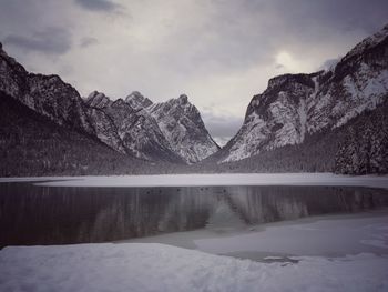 Scenic view of lake and mountains against sky