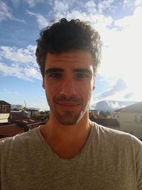 Portrait of young man against sky