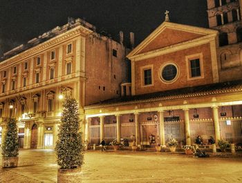 Illuminated building against sky at night