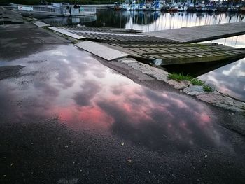 Reflection of built structure in puddle