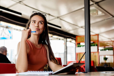 Portrait of a young woman using phone