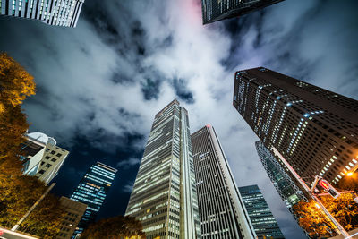 Low angle view of illuminated buildings against sky at dusk