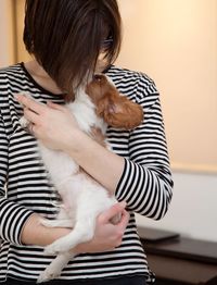 Close-up of woman embracing dog