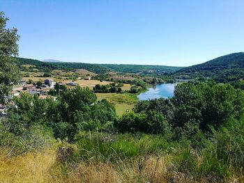 Scenic view of lake against blue sky