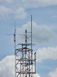 Low angle view of communications tower against sky