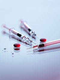 Syringes and tablets on white background, covid-19 corona virus vaccine and medicine