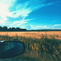 Scenic view of field against cloudy sky