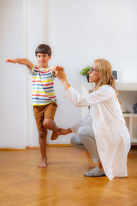 Physical therapist doing medical exam with a boy. balance test.