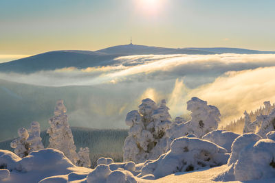 Scenic view of snowcapped mountains against sky during sunset