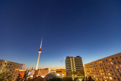 Buildings in city against blue sky