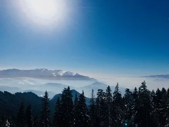 Scenic view of snowcapped mountains against blue sky