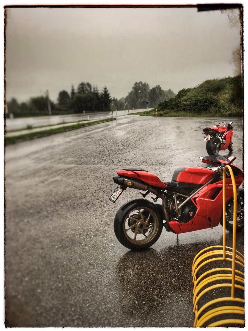 MOTORCYCLE ON ROAD AGAINST TREES