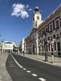 Road amidst buildings against sky in city