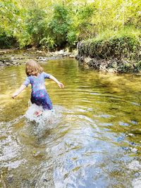 Full length of boy in river