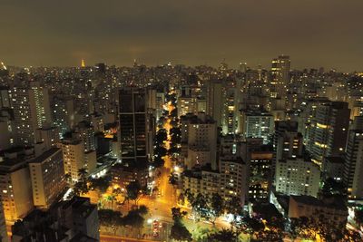 High angle view of illuminated buildings against sky at night