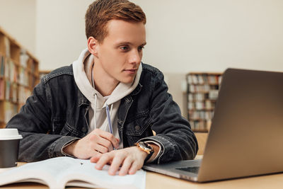 Young man using laptop at office