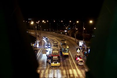 Railroad tracks in city at night