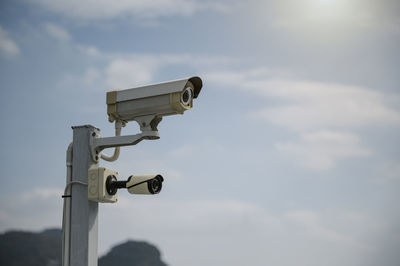 Low angle view of telephone pole against sky