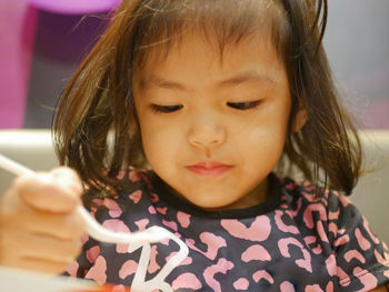 Close-up of cute girl eating food